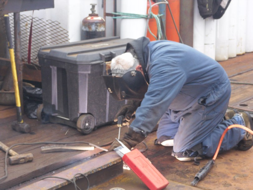 Dave welding on the deck of the M/V Sea Hunter